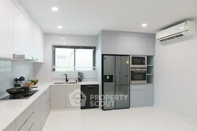Modern kitchen with sleek cabinetry, built-in appliances, and ample counter space.