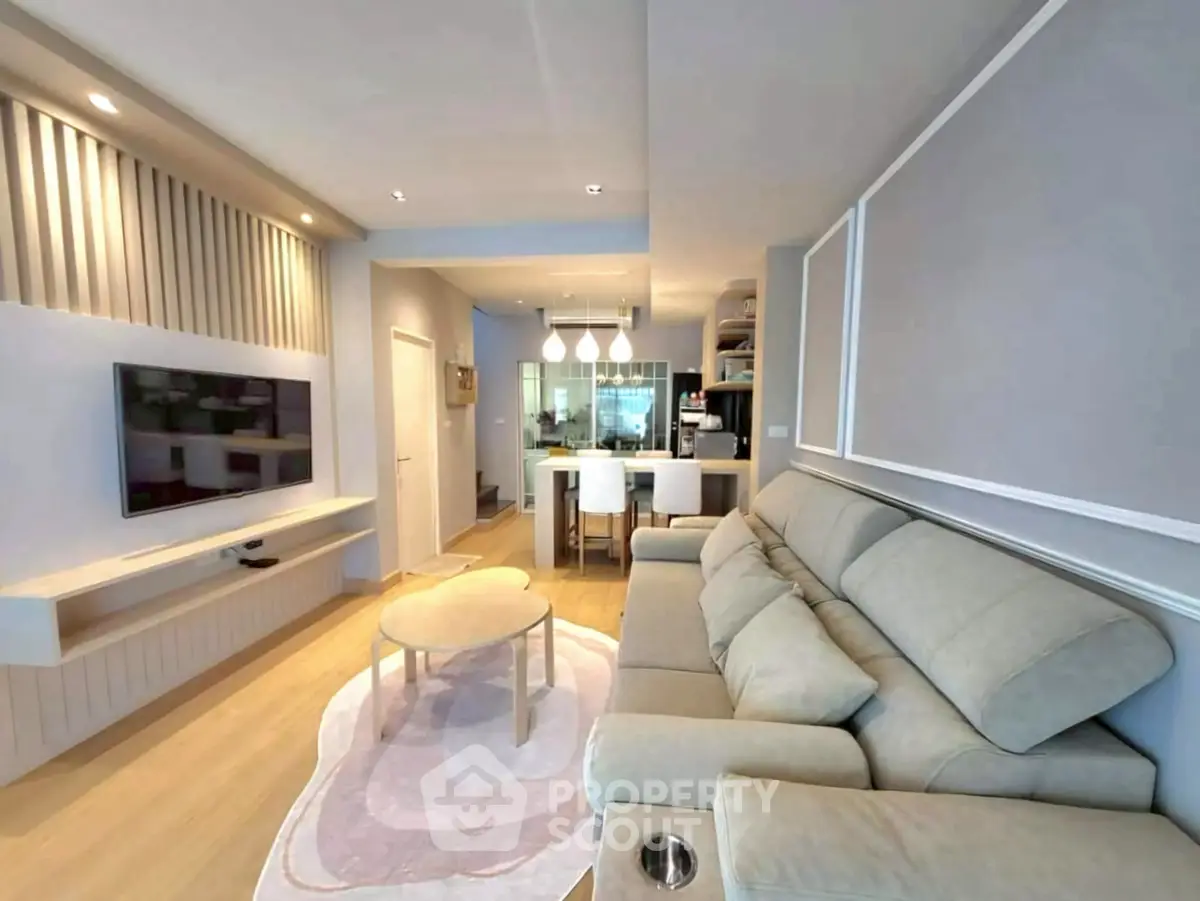 Modern living room with stylish decor and open kitchen layout