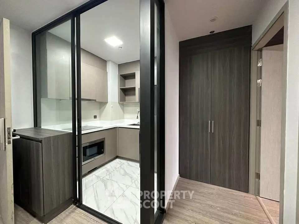 Modern compact kitchen with sleek cabinetry and built-in appliances