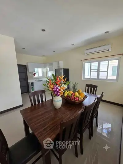 Spacious kitchen with elegant dining area and natural light, perfect for family gatherings.