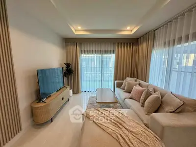 Spacious modern living room with elegant decor and large windows for natural light.