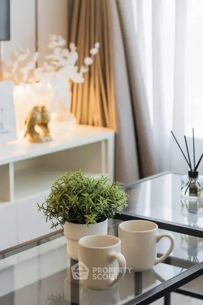 Stylish living room with modern decor, glass coffee table, and cozy ambiance.