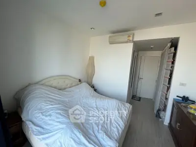 Cozy bedroom with modern air conditioning and stylish decor in a well-lit apartment.