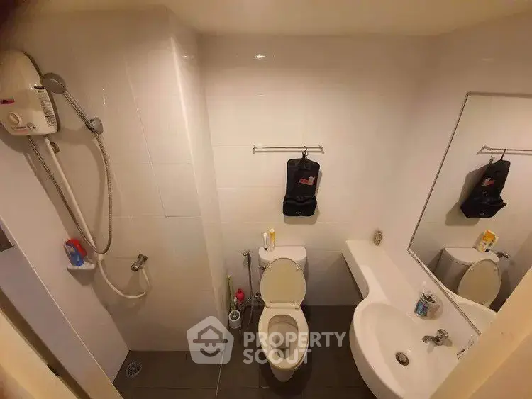 Compact bathroom with shower and modern fixtures in urban apartment
