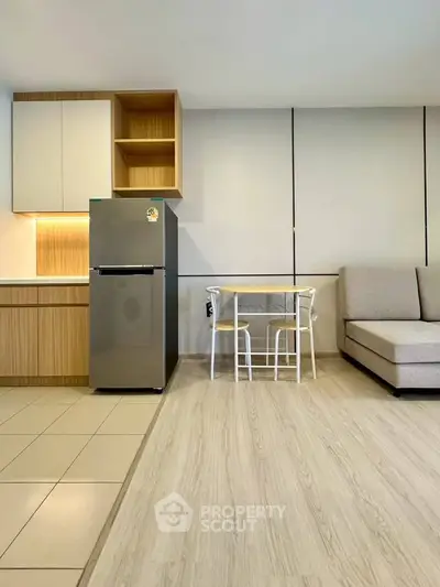 Modern open-plan kitchen and living area with sleek design and cozy furniture.