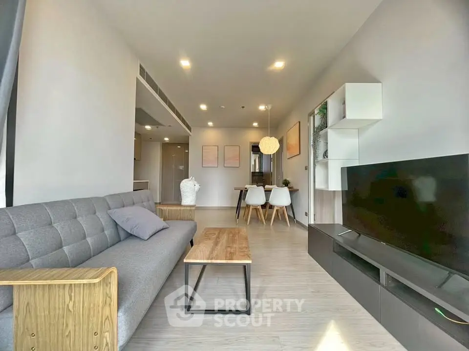 Modern living room with sleek furniture and natural light, perfect for contemporary urban living.