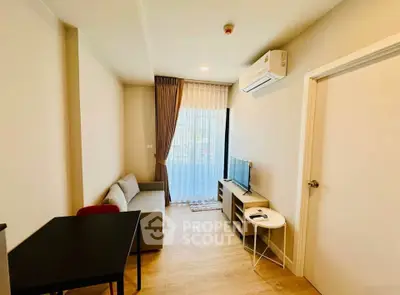 Modern living room with cozy sofa, TV, and air conditioning in a bright apartment.