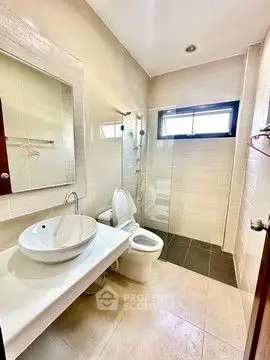 Modern bathroom with sleek fixtures and glass shower enclosure