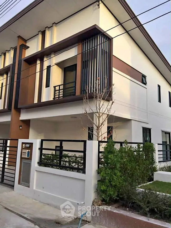 Modern two-story townhouse with sleek design and private garden area.