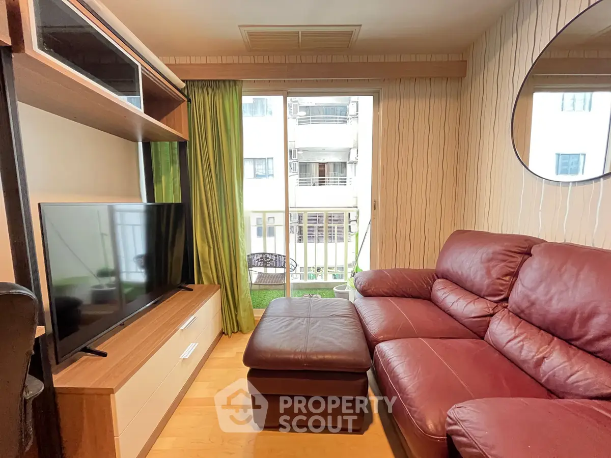 Cozy living room with red leather sofa and modern entertainment unit
