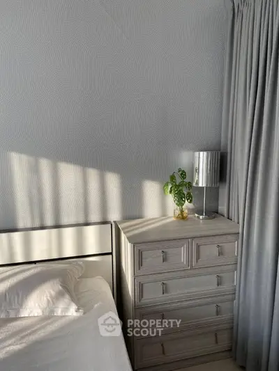 Cozy bedroom with modern dresser and soft lighting