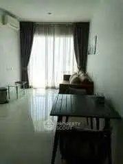 Modern living room with large window and elegant curtains, featuring a cozy sofa and sleek dining table.