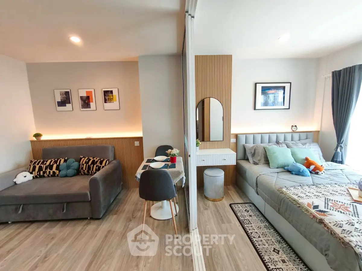 Modern studio apartment with stylish decor, featuring a cozy living area and a comfortable bedroom.