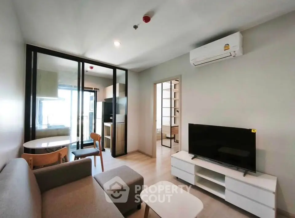 Modern living room with sleek furniture and open layout in a stylish apartment.