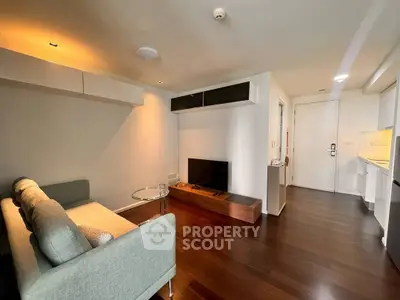 Modern living room with sleek furniture and wooden flooring