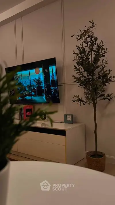 Modern living room with stylish decor and wall-mounted TV