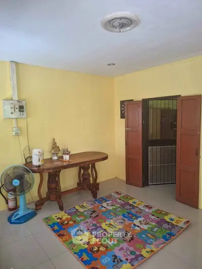 Cozy interior space with colorful play mat and wooden table, perfect for family activities.