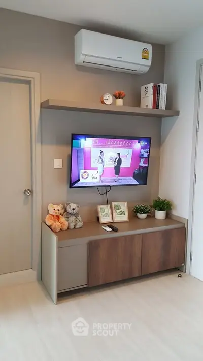 Modern living room with wall-mounted TV and stylish shelving