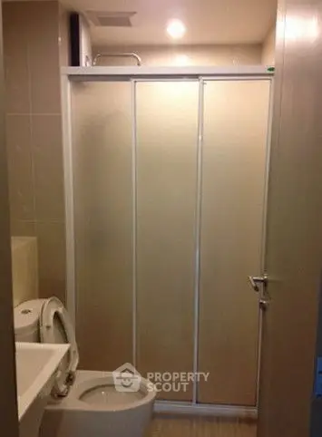 Modern bathroom with sliding shower doors and sleek fixtures
