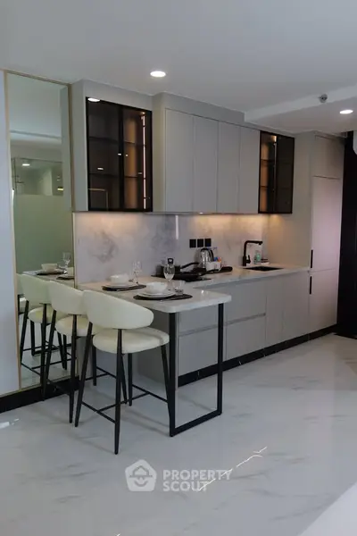 Modern kitchen with sleek cabinetry and breakfast bar seating