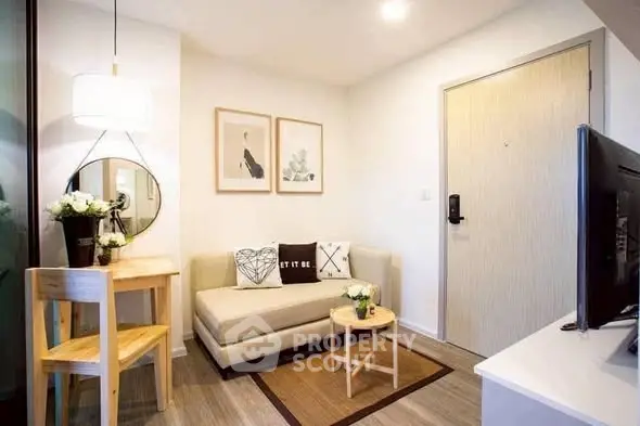 Charming compact living room with modern decor and cozy seating area.