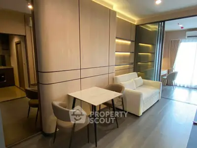 Modern living room with sleek design and natural lighting, featuring a cozy sofa and elegant dining area.