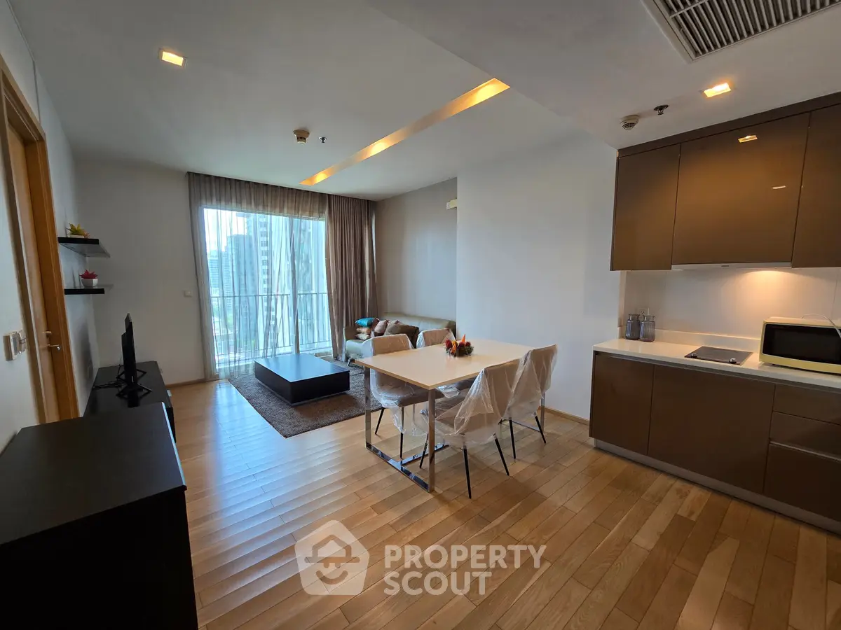 Modern living room with open kitchen and large windows in a stylish apartment