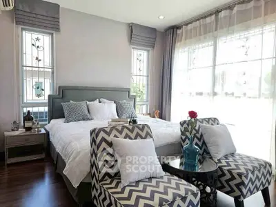 Luxurious bedroom with stylish decor and large windows for natural light.
