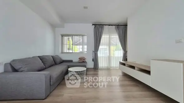 Spacious modern living room with gray sofa and stylish decor