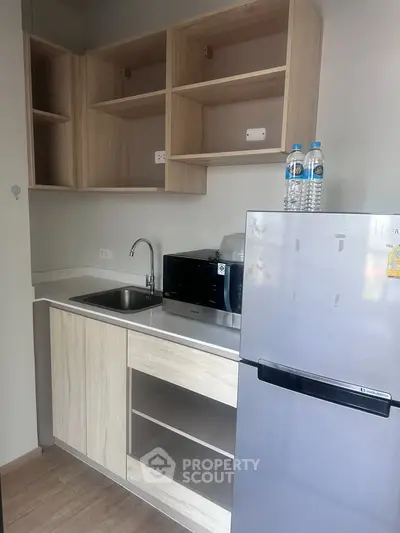 Modern compact kitchen with sleek cabinetry and stainless steel appliances, perfect for urban living.