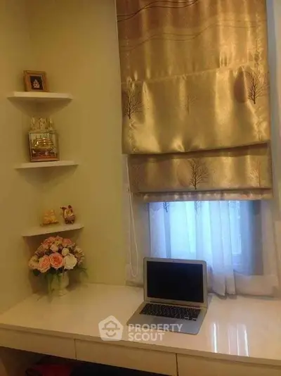 Cozy study nook with elegant curtains and decorative shelves in a modern home.