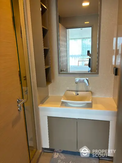 Modern bathroom with sleek sink and mirror in stylish apartment