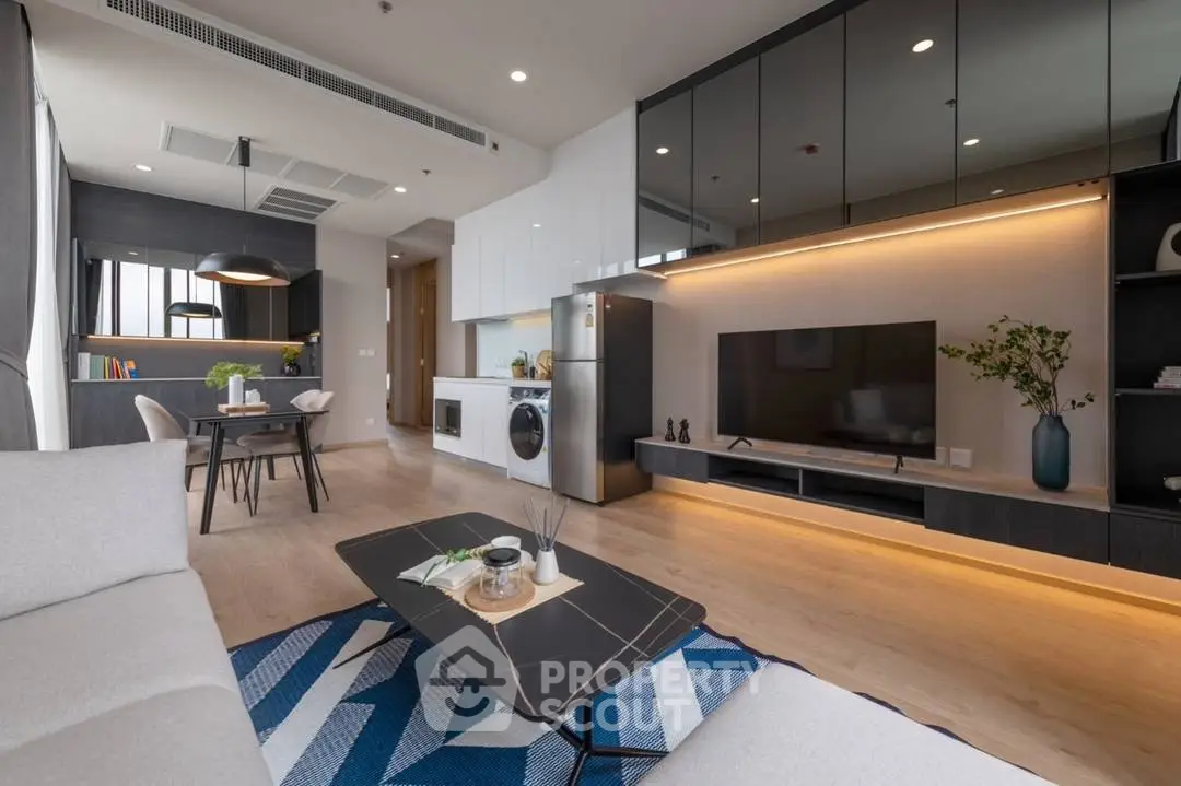 Modern open-plan living room with sleek kitchen and stylish decor