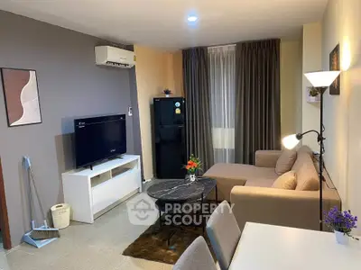 Modern living room with stylish decor, cozy sofa, and sleek TV setup in a contemporary apartment.