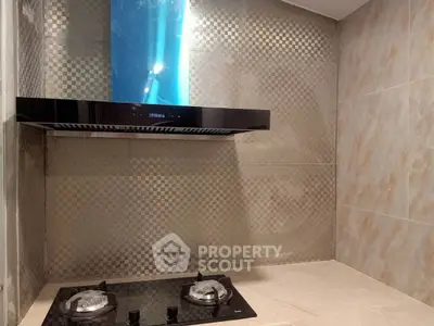 Modern kitchen with sleek gas stove and stylish backsplash