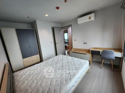 Modern bedroom with minimalist furniture and air conditioning in a stylish apartment.