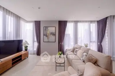 Luxurious modern living room with panoramic city views and elegant decor.