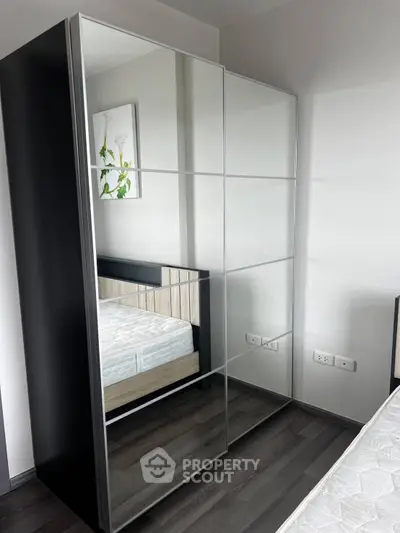Modern bedroom with mirrored wardrobe and stylish decor