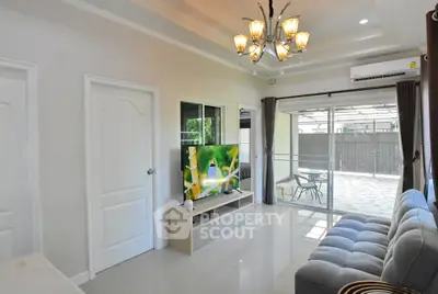 Modern living room with elegant chandelier and spacious seating area
