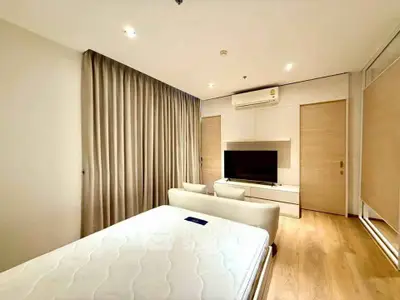Spacious modern bedroom with sleek design and natural light