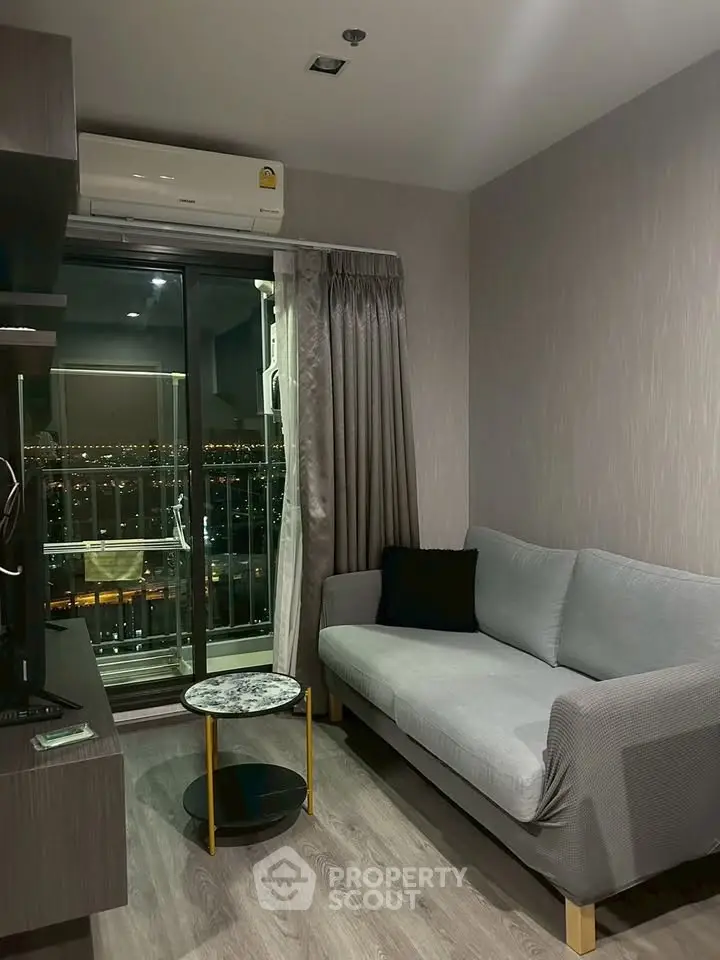 Modern living room with city view, featuring a cozy sofa and stylish decor.