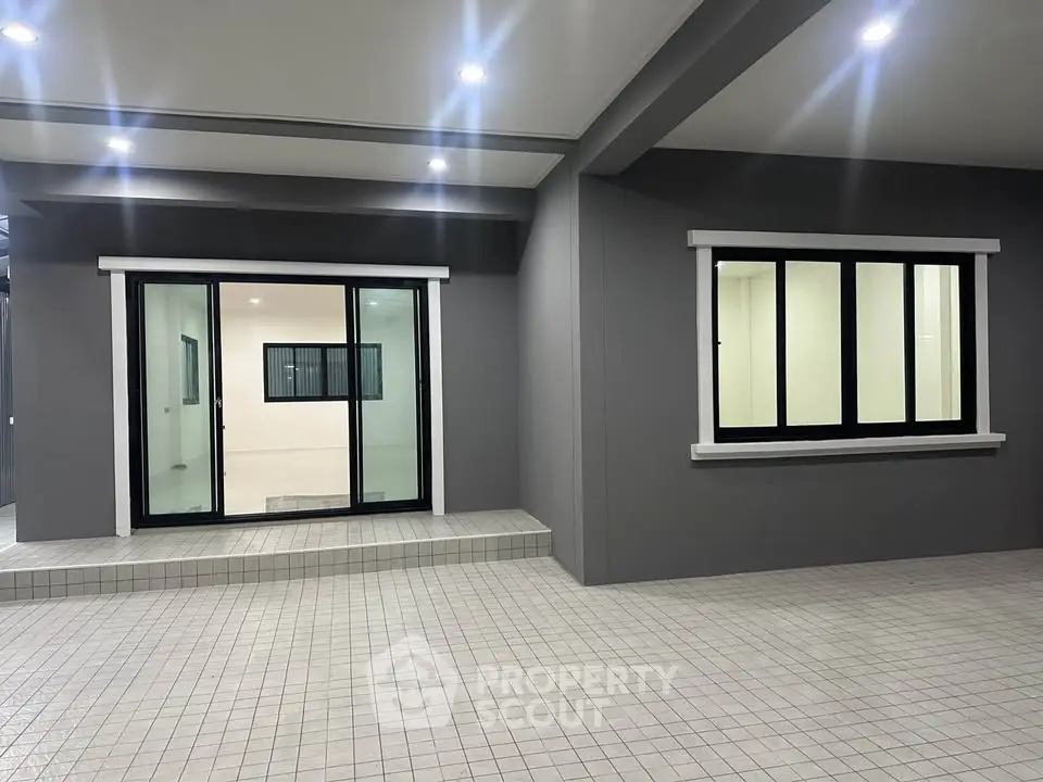 Modern exterior with sleek windows and tiled flooring, perfect for contemporary living.
