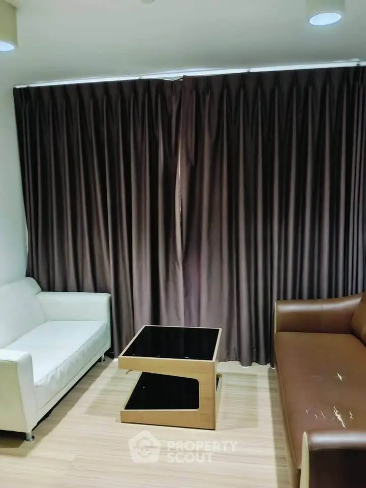 Cozy living room with modern sofas and stylish coffee table, perfect for relaxation.