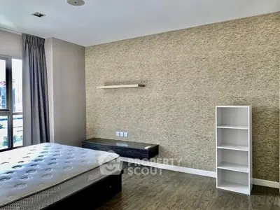 Spacious bedroom with modern design and ample natural light