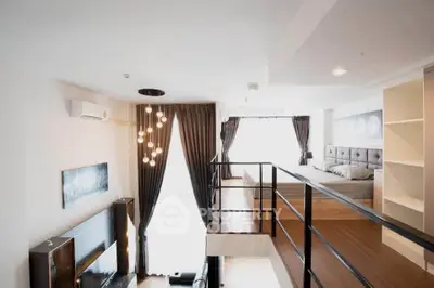 Modern loft apartment with stylish interior, featuring a mezzanine bedroom and spacious living area.