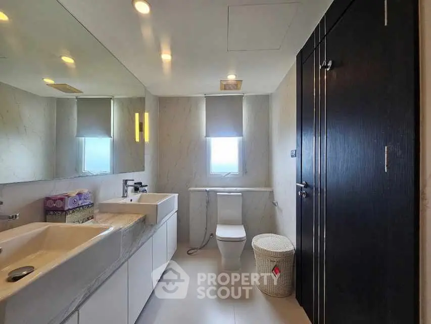 Luxurious modern bathroom with dual sinks and elegant fixtures.