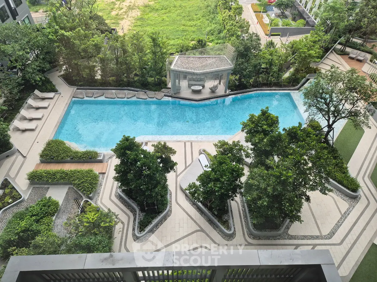 Luxurious apartment complex with stunning outdoor pool and lush greenery, perfect for relaxation and leisure.