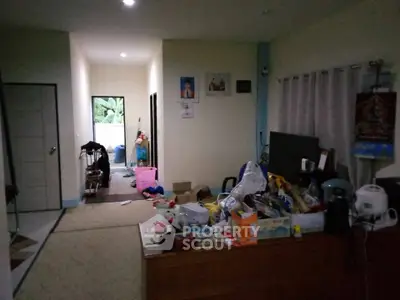 Spacious living area with cluttered decor and natural light