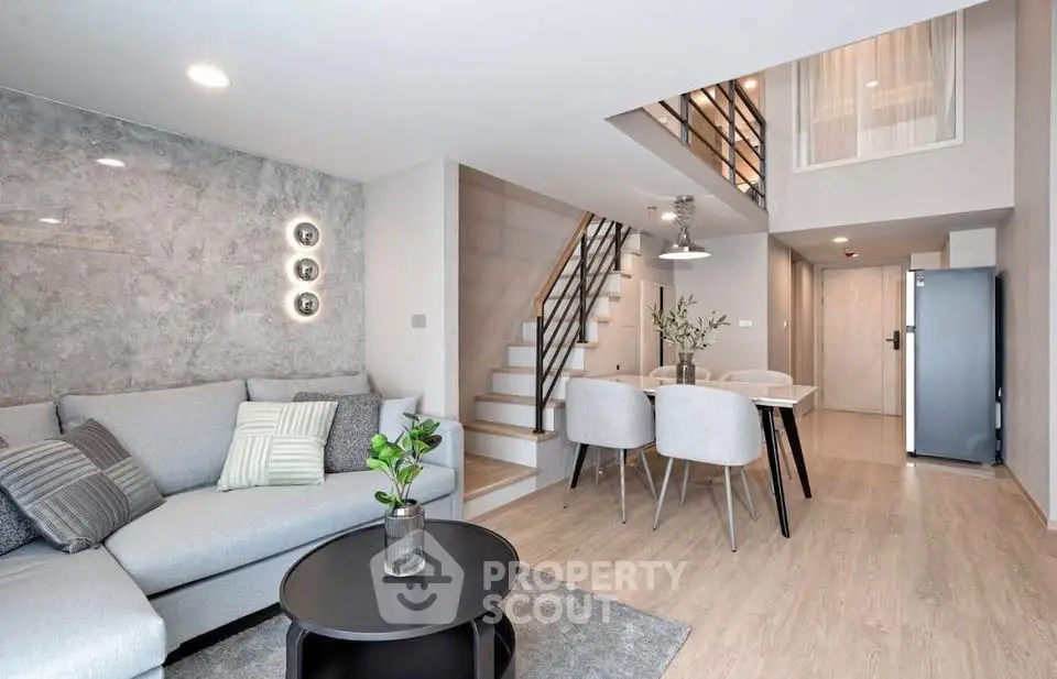 Modern duplex living room with stylish decor and open staircase