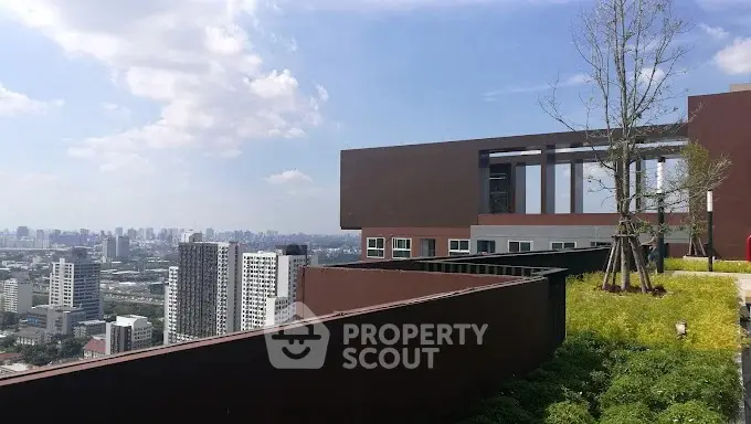 Stunning rooftop view with lush greenery and city skyline in the background.